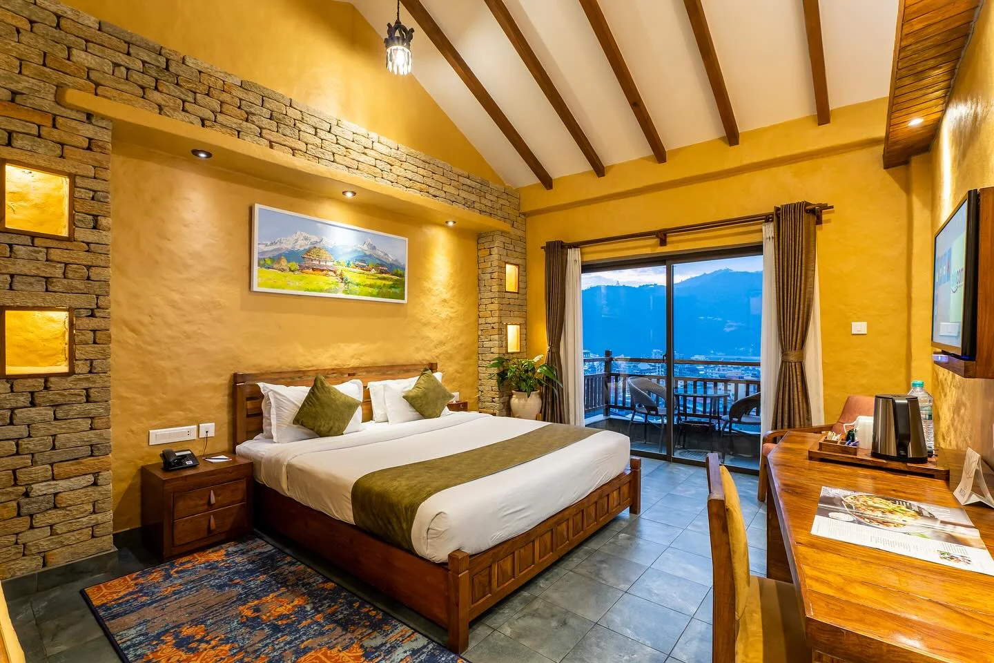 Deluxe Room with stone wall, timber ceiling and balcony door