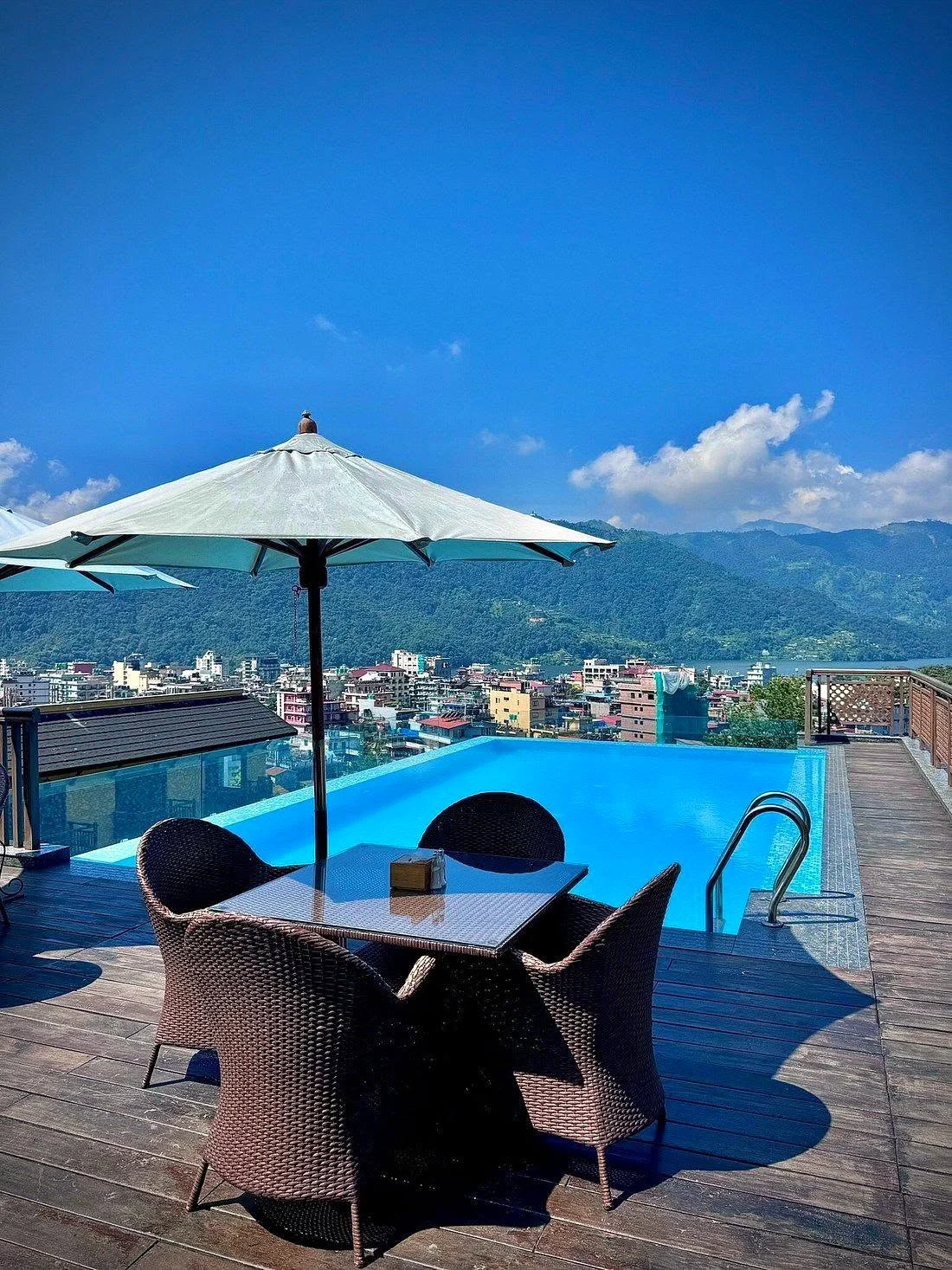 The pool with an umbrella and blue sky
