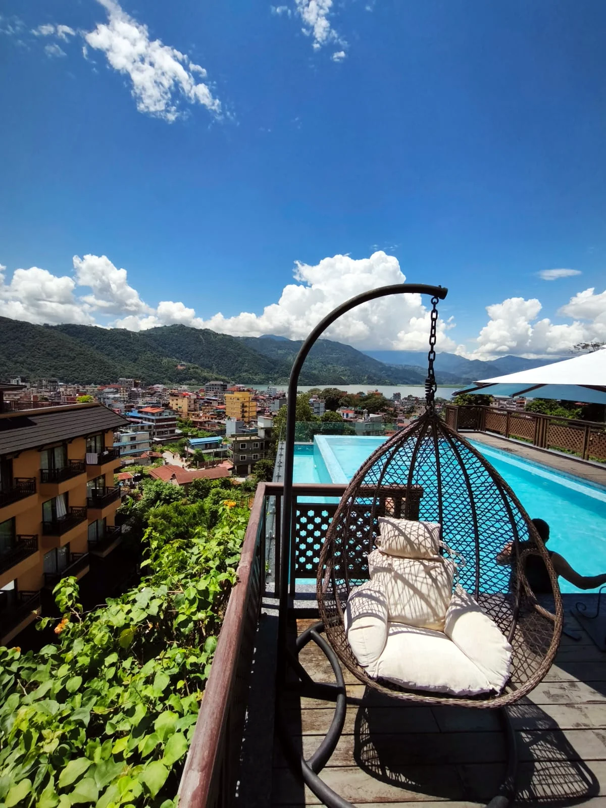 A swing chair above the pool and Pokhara
