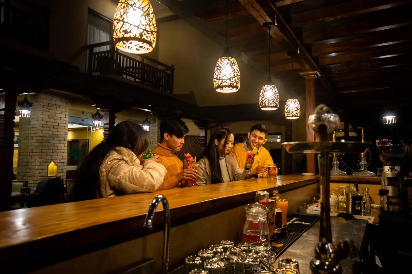 Guests at the bar at Bar Peepal Resort in the evening
