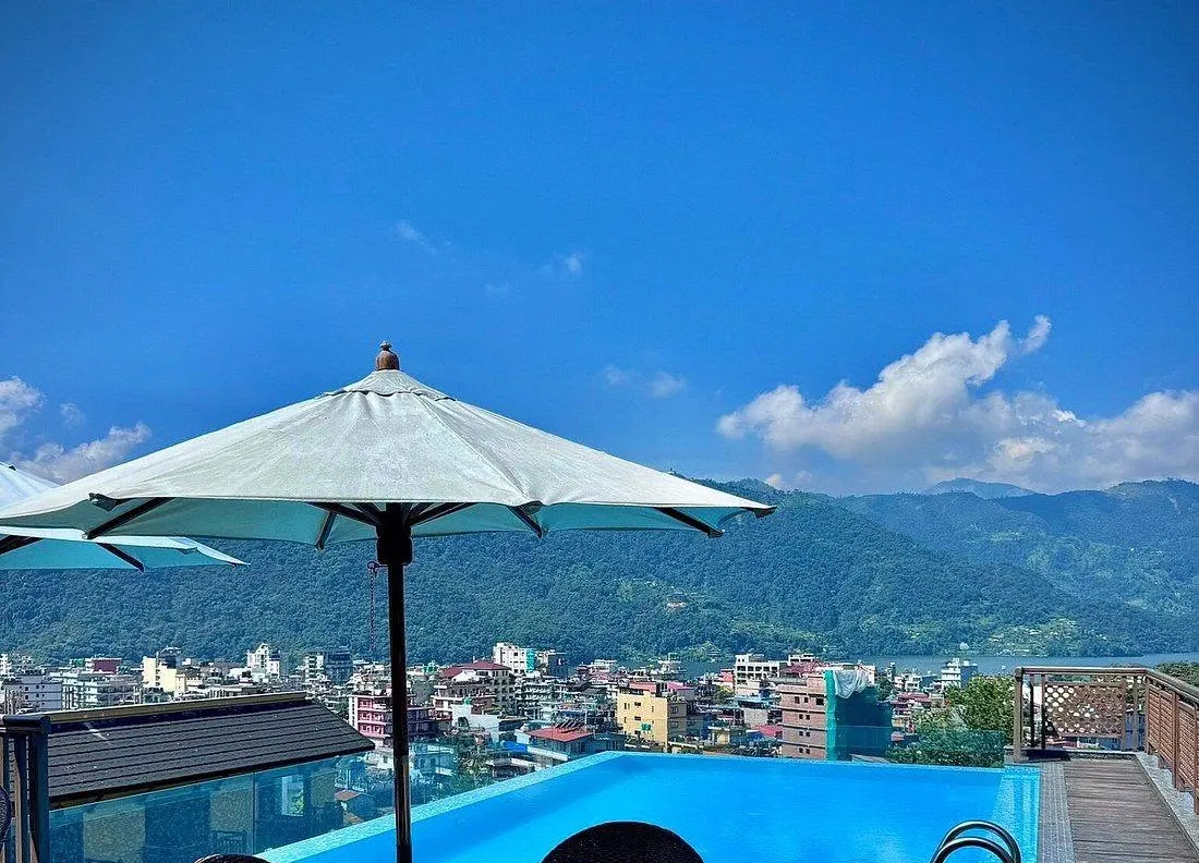 The rooftop infinity pool at Bar Peepal Resort facing the hills of Pokhara